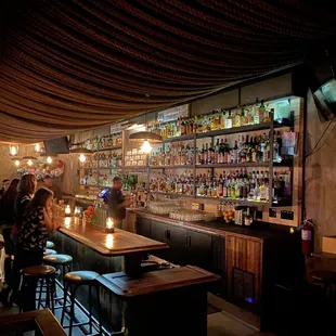 a bar with people sitting at the bar