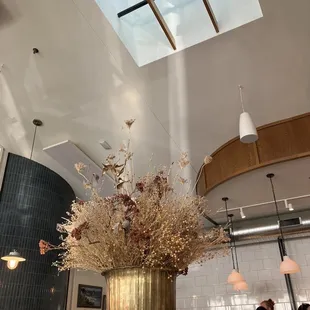 a large gold vase with flowers in it