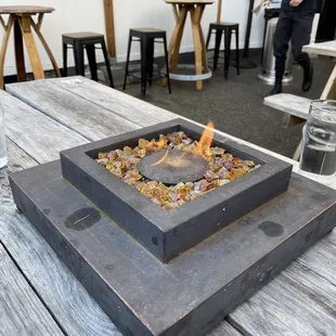 a fire pit on a picnic table