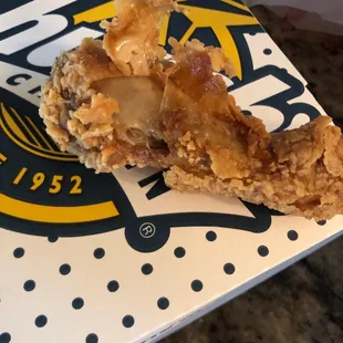 a half eaten piece of fried chicken