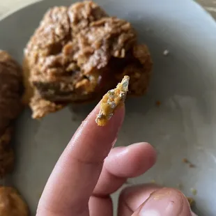 a hand holding a piece of food