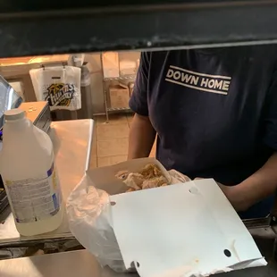 a man holding a box of food