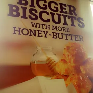a sign for a new bigger biscuits with more honey butter