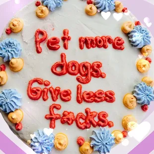 a birthday cake with the words pet more dogs give less faces