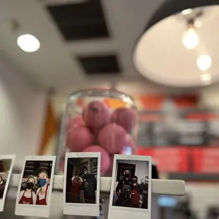 a display of polaroid photographs of people