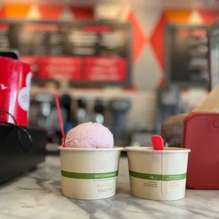 two cups of ice cream on a counter