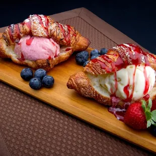 two pastries with ice cream and strawberries