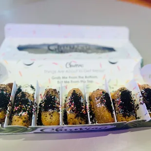 Addict - caramel, choconella, and strawberry jam fillings drizzled with white chocolate with sprinkles and Oreo toppings.