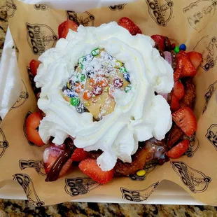 a dessert with whipped cream and strawberries