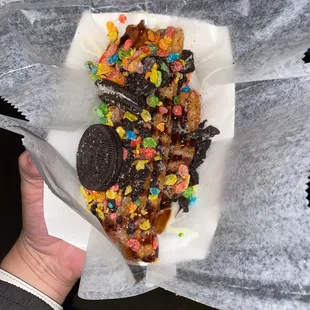 a person holding a piece of food