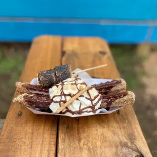 a plate of churros on a picnic table