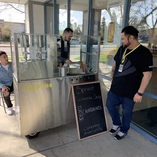 a man standing in front of a kiosk