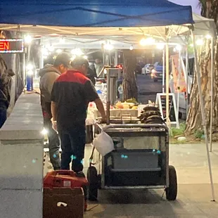 a man pushing a cart of food