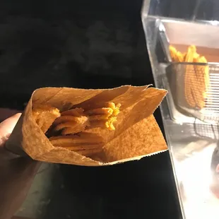 a person holding a bag of food
