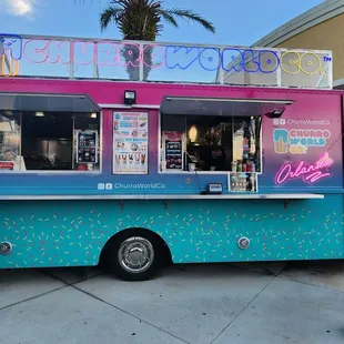 a woman standing in front of a food truck