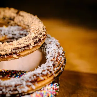 a stack of donuts with sprinkles