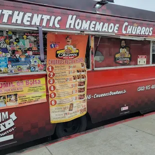 Side of the truck view with menu, hours &amp; phone number