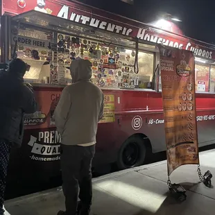 two people ordering food from a food truck