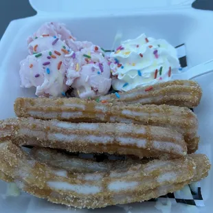 a close up of a churros with ice cream and sprinkles
