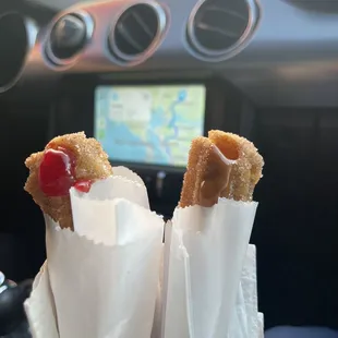 two churros with a cherry on top