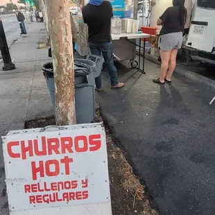 a sign for churros hot sauces