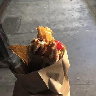 a person holding a bag of churros