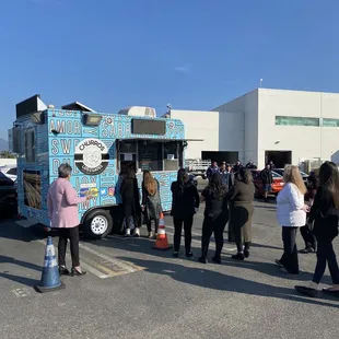 people standing in a parking lot