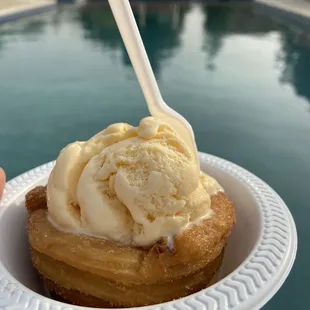 a person holding a plate of ice cream