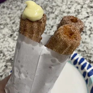 Churro with vanilla filling and two regular churros.