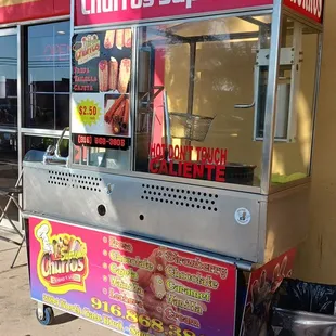a hot dog cart on the sidewalk