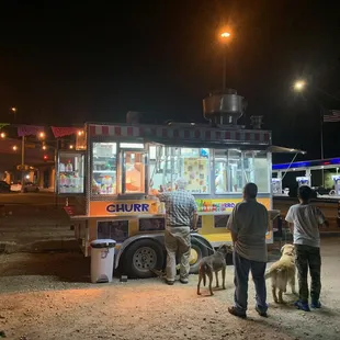 people standing in front of a food truck