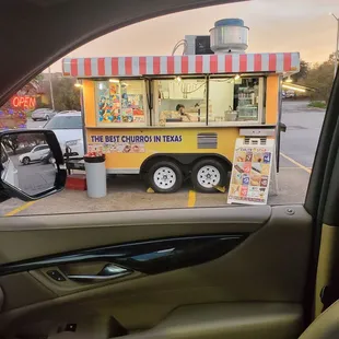 a view of a food truck from inside a car