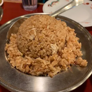 a plate of rice with a spoon