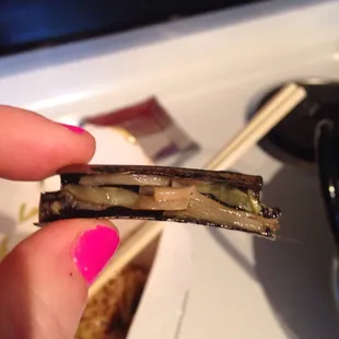 a person holding a piece of food