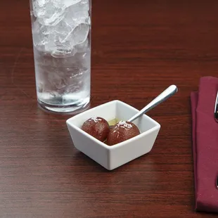 a bowl of chutney and a glass of water