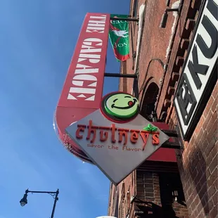 a neon sign on a brick building