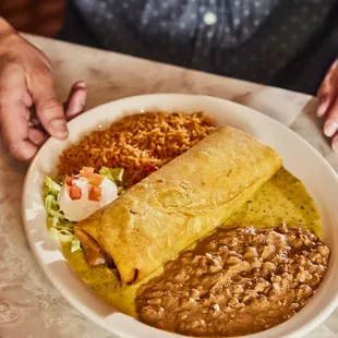 The Chuychanga! A flour tortilla fried and filled with chicken, cheese, cilantro and more. Served with sour cream and your choice of sauce.