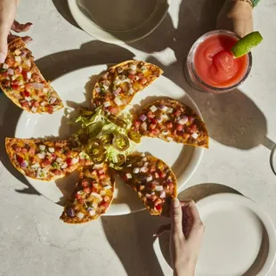 Nachos - Toastada chips, refried beans &amp; cheese with lettuce, pico de gallo &amp; jalapeños.
