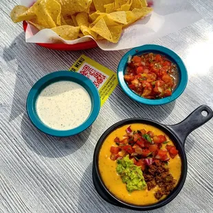 Chuy&apos;s signature Queso - a blend of melted cheese, Green Chile and Ranchero Sauces. Only $5 Monday - Friday 3pm-6pm!