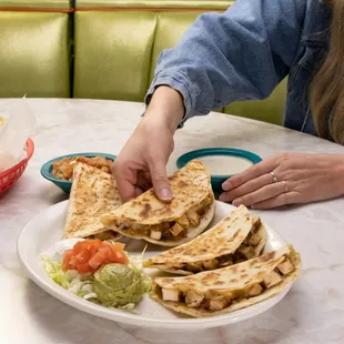 Quesadillas made with handmade tortillas, fajita chicken, cheese, green chiles and onion. Comes with guacamole, sour cream and tomatoes.