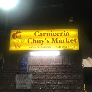 a brick building with a yellow sign