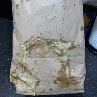 Bag of chips dipped in queso.