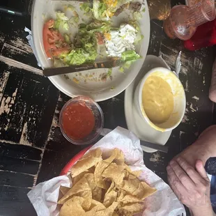 Tostadas, cheese sauce, salsa, chips. Empty plate was chili relleno #2