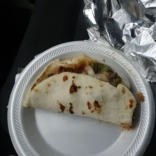 a burrito on a paper plate