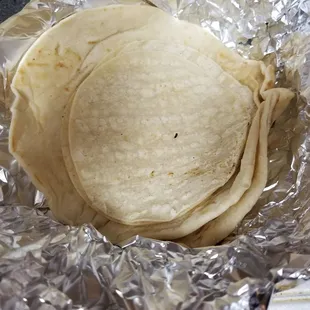 A mixture of flour and corn tortillas to go with an order of fajitas upon request. Both are good, so def ask for both!