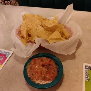 a bowl of chips and a bowl of salsa