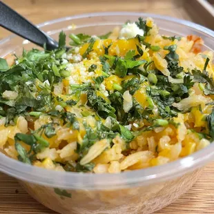 Side of rice topped with cheese and cilantro