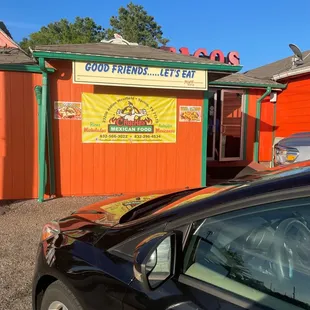 a car parked in front of a restaurant