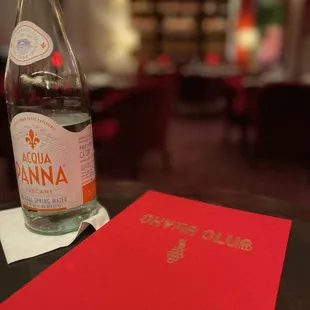 a bottle of water and a menu