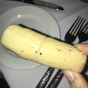 a person holding a piece of food